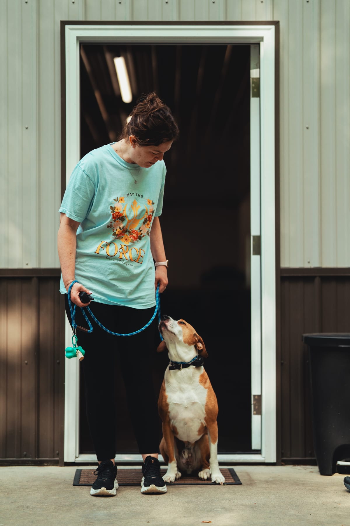 A Deer Creek staff member with a calm, attentive dog at the resort